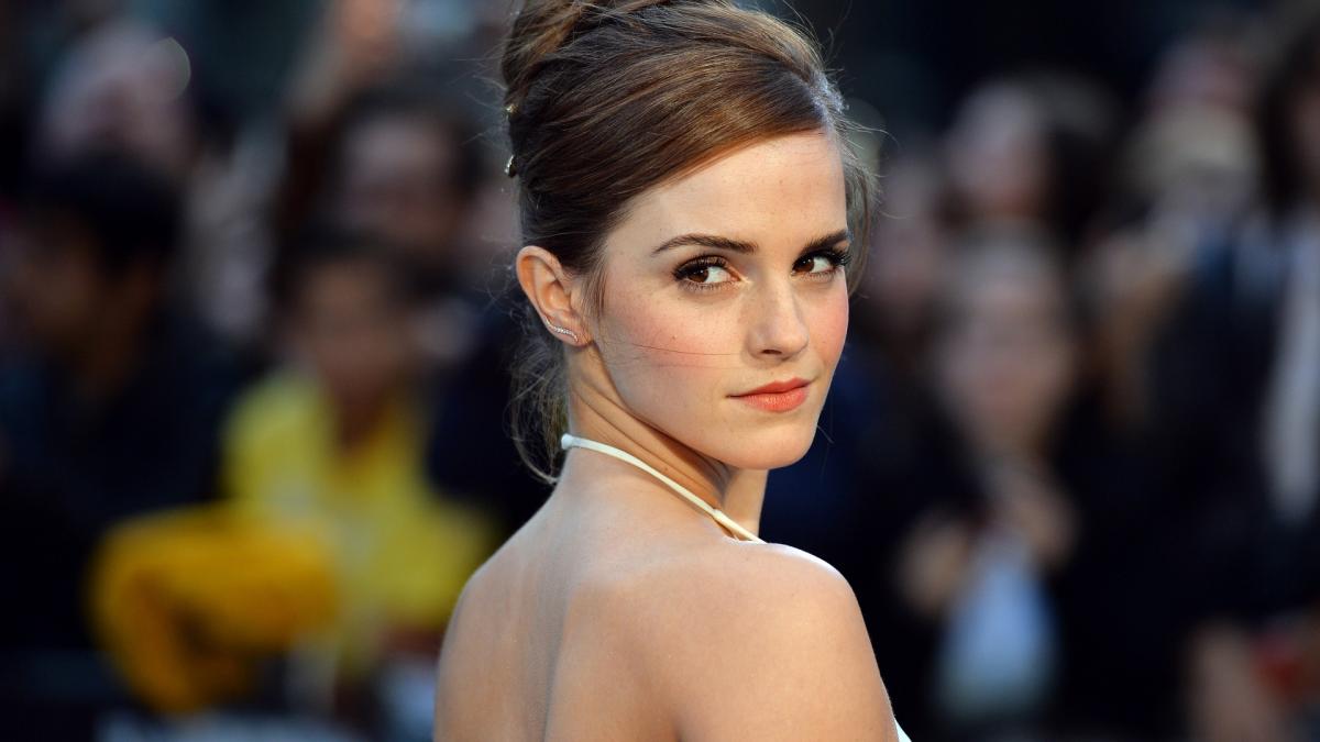 Emma Watson in a white dress looking back over her shoulder with an elegant smile (1920x1080)