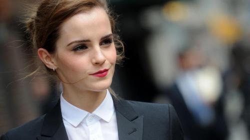 Emma Watson confidently posing in a tailored business suit (1920x1080)